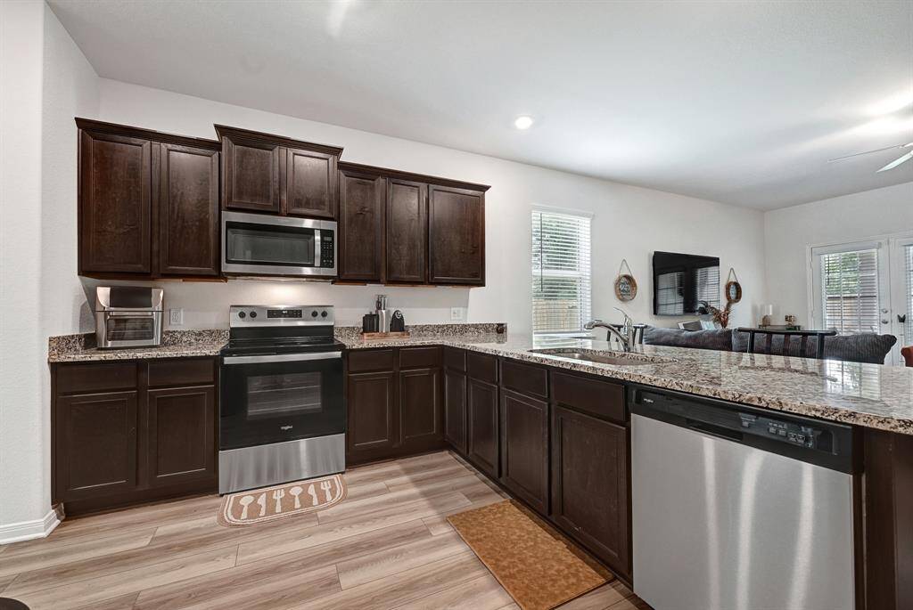 This kitchen offers plenty of storage! The richly colored cabinets are easy to maintain and keep clean.