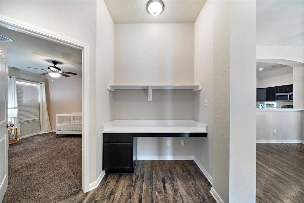 Tucked between the living and secondary bedroom, this versatile study nook features a built-in desk with storage and a floating shelf, making it ideal for work, homework, or creative projects. The convenient location allows for a dedicated workspace without sacrificing open flow.