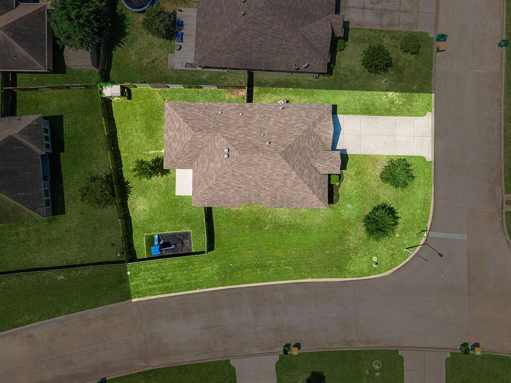 Bird’s-eye view highlights the true expanse of the corner lot, revealing broad green spaces and a fully fenced backyard ideal for recreation or gardening. The generous driveway and well-maintained landscaping enhance privacy and curb appeal at 1074 Pleasant Bend, making this home stand out in Briar Grove.