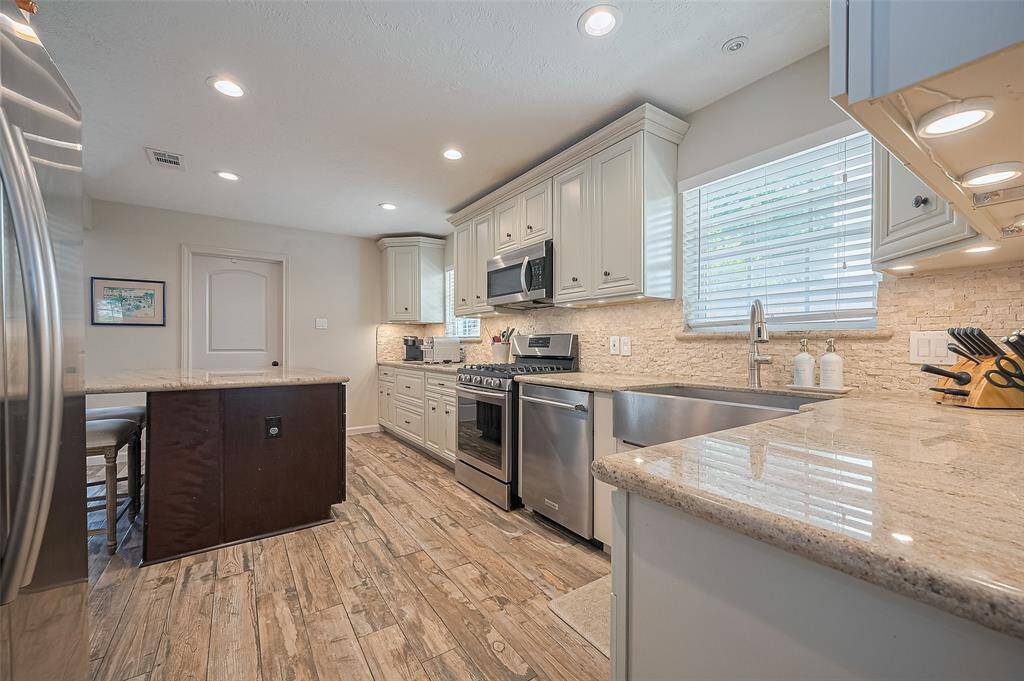 Another view of this incredibly spacious and functional kitchen.