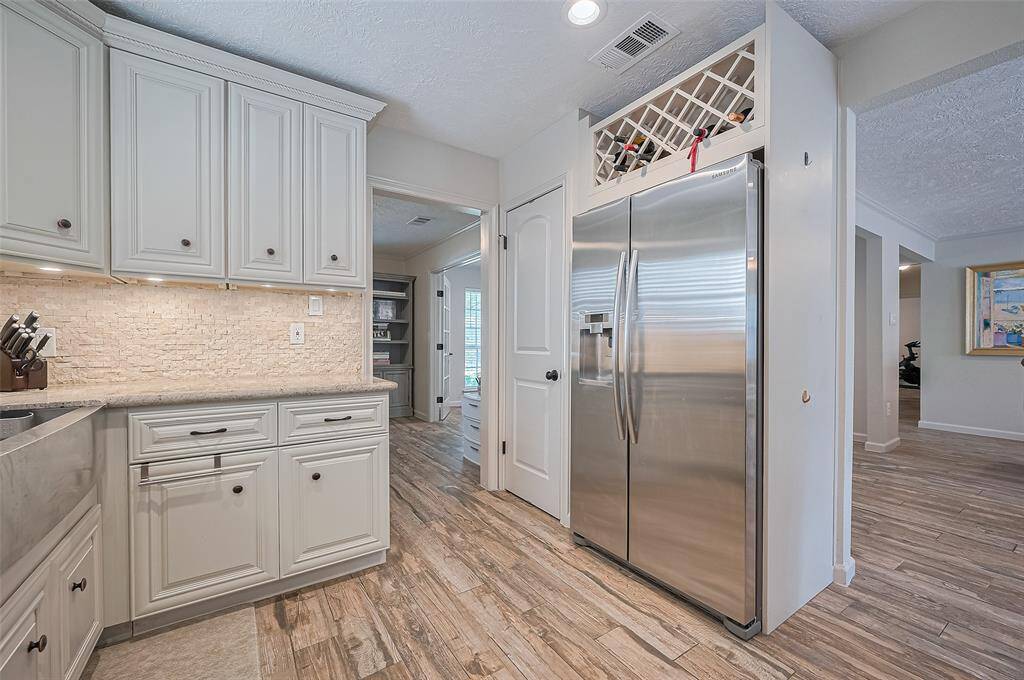 Under-cabinet lighting, a built-in wine rack, pantry, and a side-by-side refrigerator/freezer—what more could you ask for?