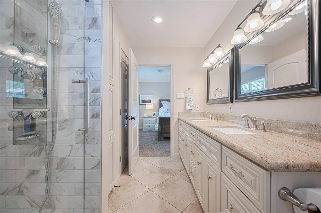 Another angle of the bathroom showcases the abundant storage on the wall opposite the vanities—perfect for linens, toiletries, and everyday essentials.