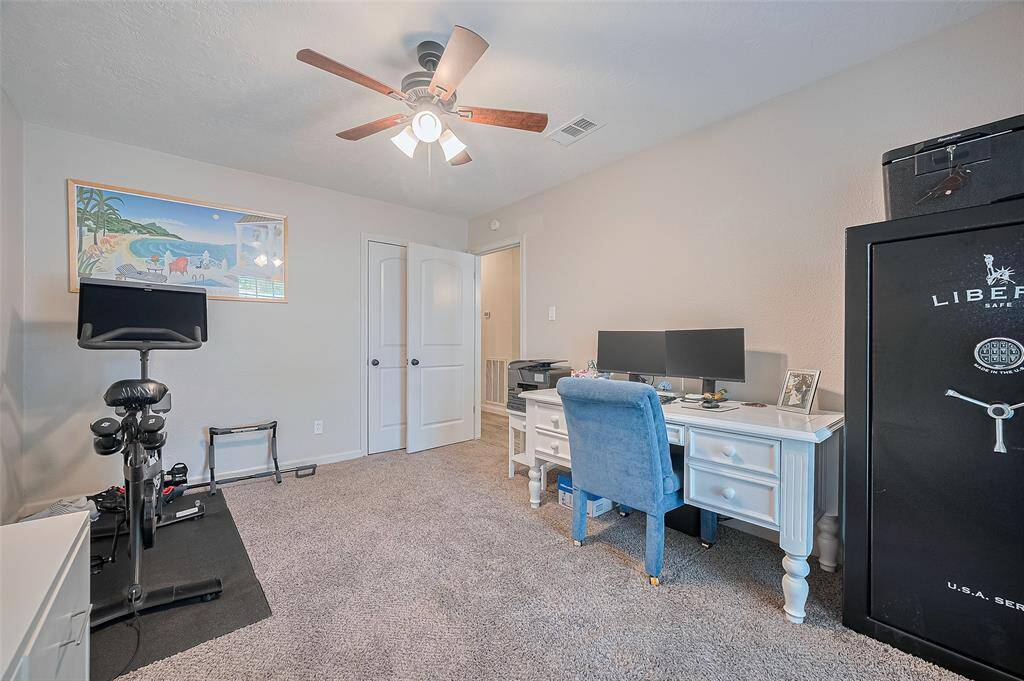 The third secondary bedroom offers similar features, including a large window, ceiling fan with light fixture, and a generous closet for ample storage.