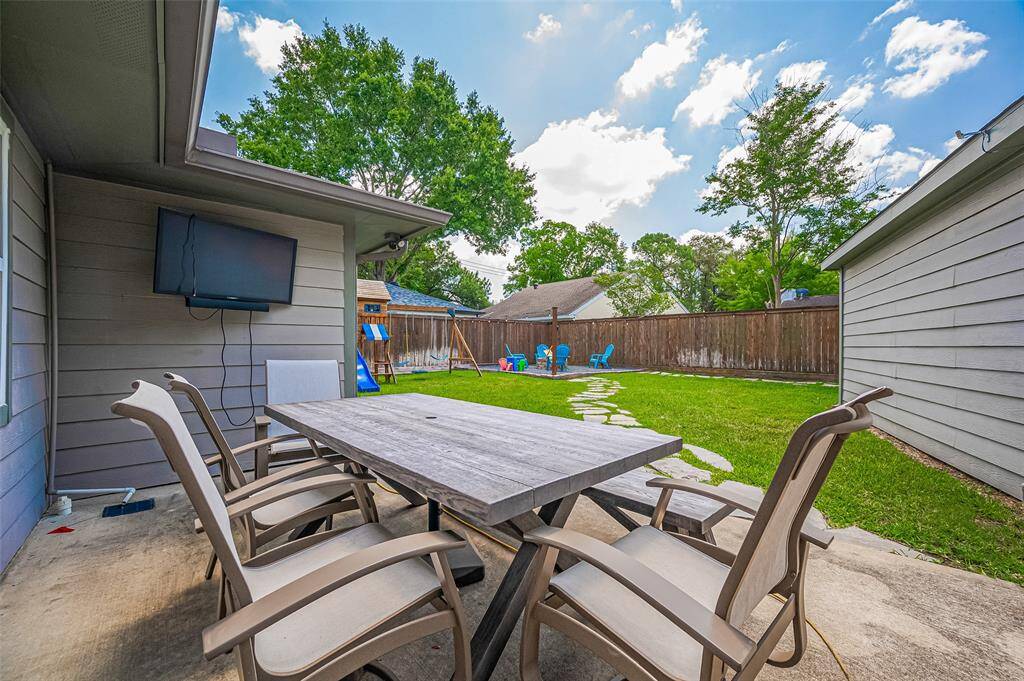 The backyard is a true retreat, offering everything you need for relaxation, play, and entertaining. Just off the utility room, the spacious patio provides the perfect setting for outdoor dining and gatherings.