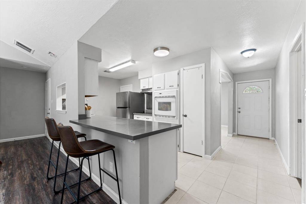 Add a few barstools for some informal breakfast bar seating.
