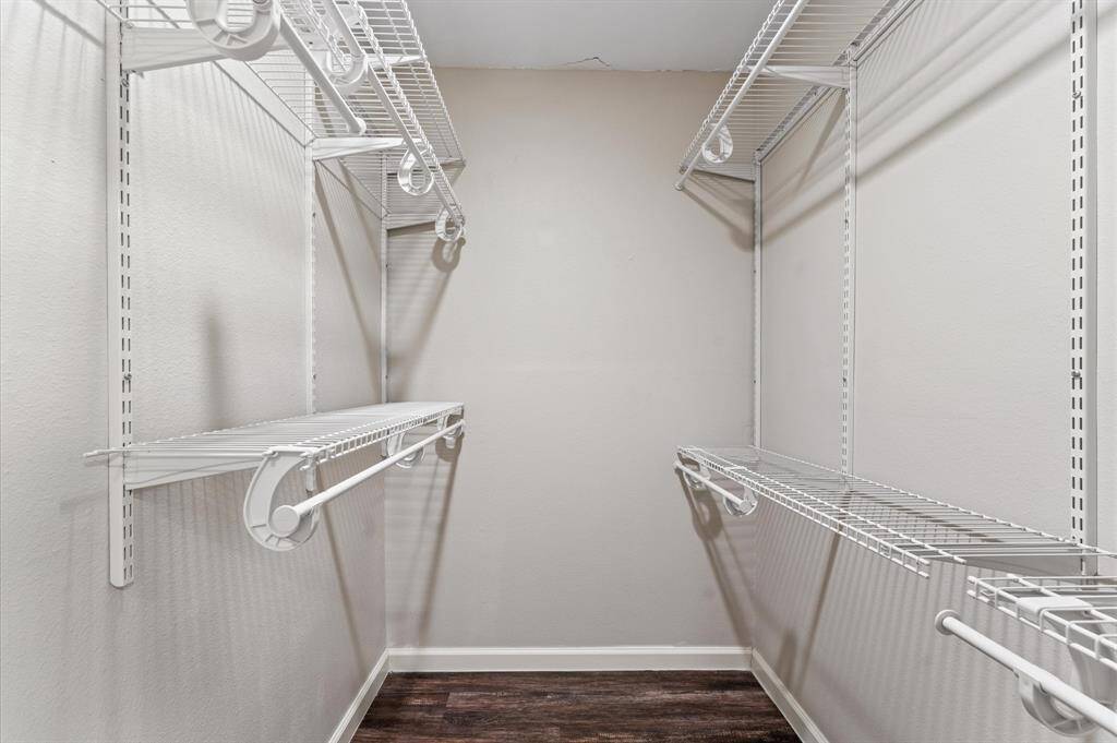 A roomy walk-in closet in the primary offers plenty of built-in shelving.