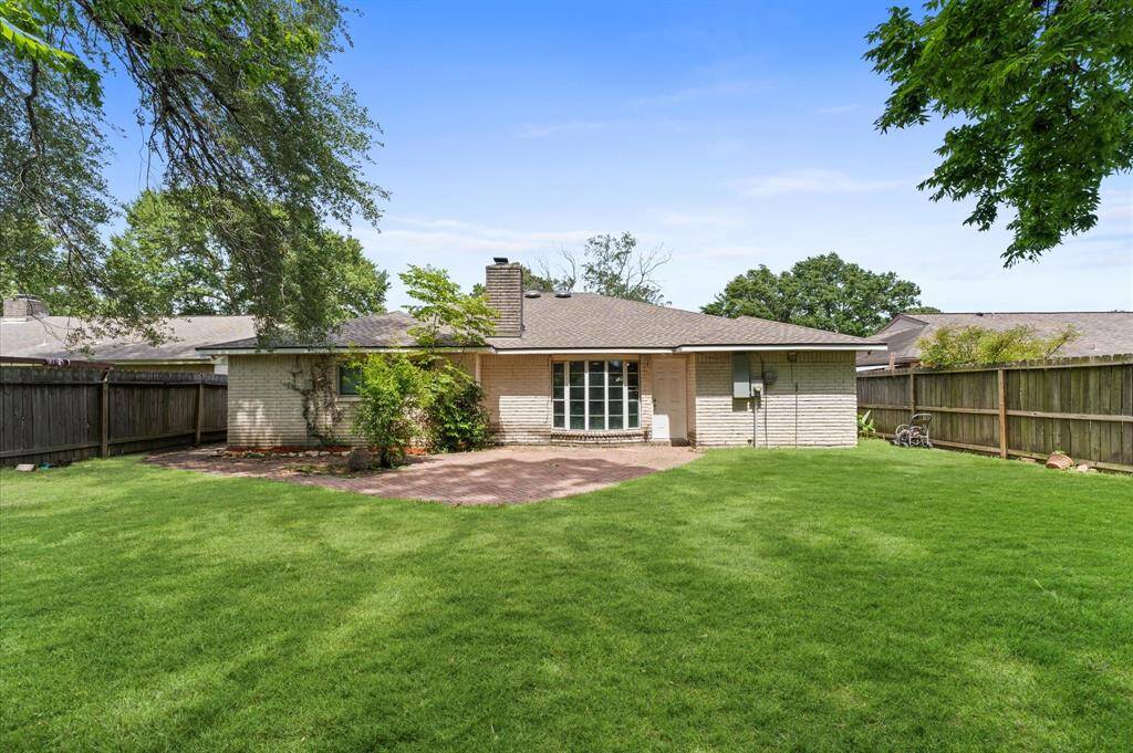 A bricked patio offers a great spot to sit and relax or host a backyard barbecue.