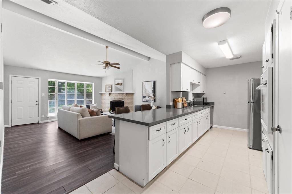 The classic galley kitchen overlooks the living room and provides an easy flow between the rooms.