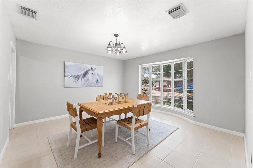 At the front of the home in front of a bay window, you'll find a well-appointed formal dining room. Whether you utilize the space as a dining room or convert it to a study, this spacious room affords some possibilites.