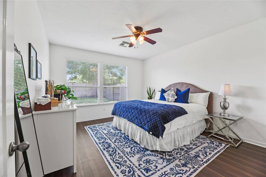 Bright and airy primary bedroom with new luxury vinyl flooring.
