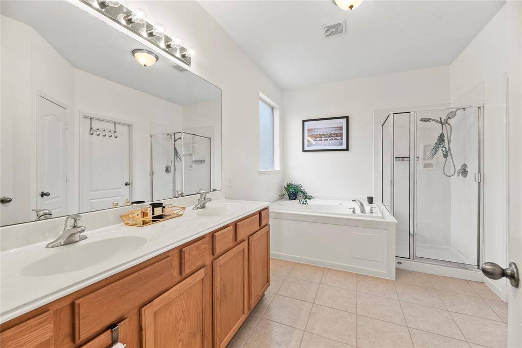 Primary Bathroom featuring double sinks