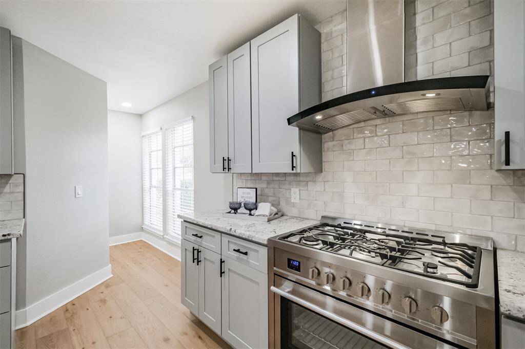 Classic subway tile and Ice Pearl granite counters give the kitchen a feel of modern and traditional rolled into one. Just beyond the windows is the MASSIVE pantry.