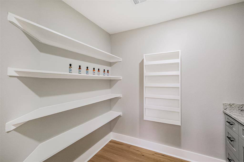 This pantry is a room all in it's own! With storage for dry goods and a custom spice rack, there is plenty of space for all the things.