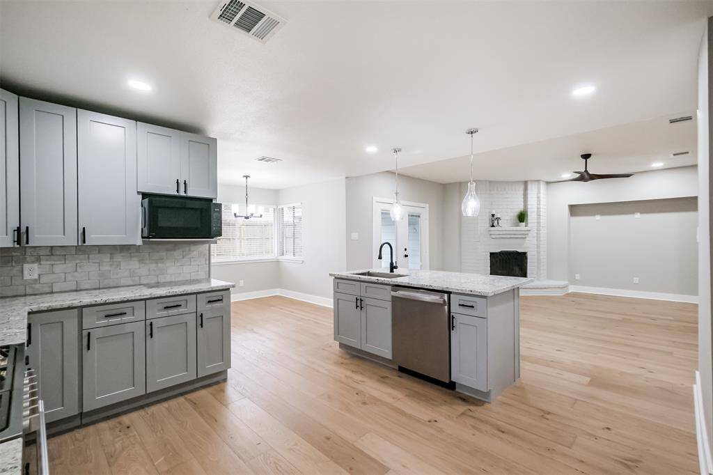 This view shows the seamless way all the living spaces flow together. Just across from the island is the spacious and bright dining area.