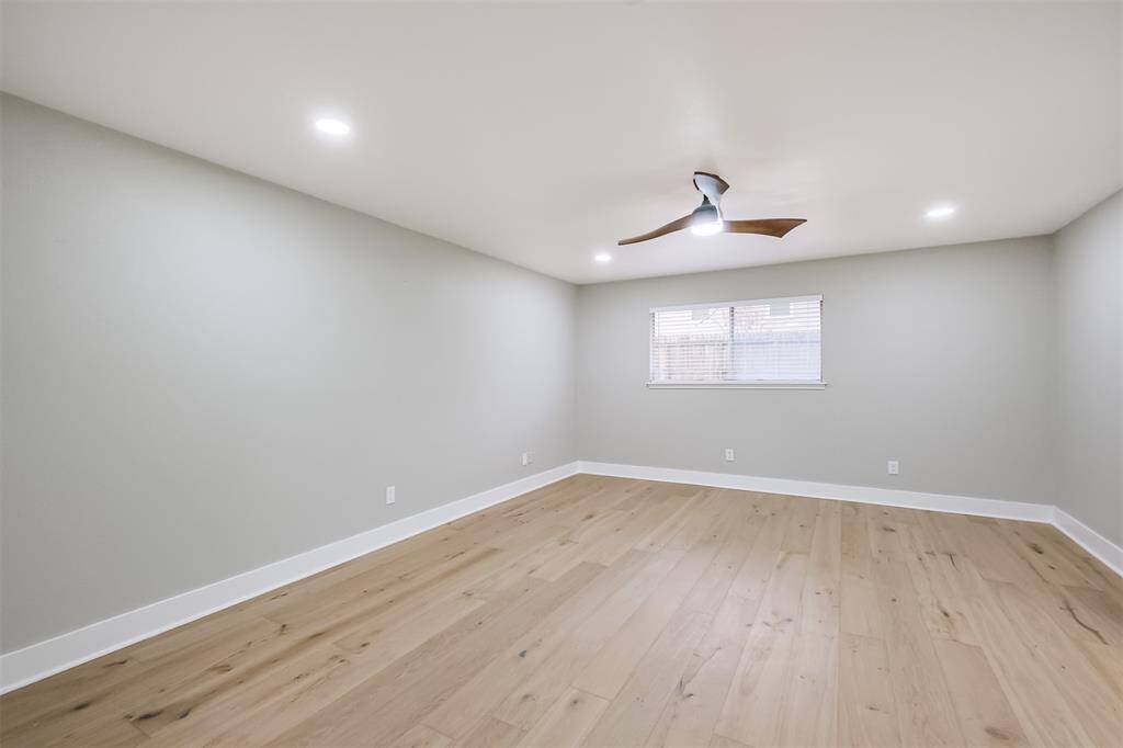 The view into the back garden brings the outdoors into this sanctuary. Notice the abundant lighting and more of the Hardwood Oak floors.