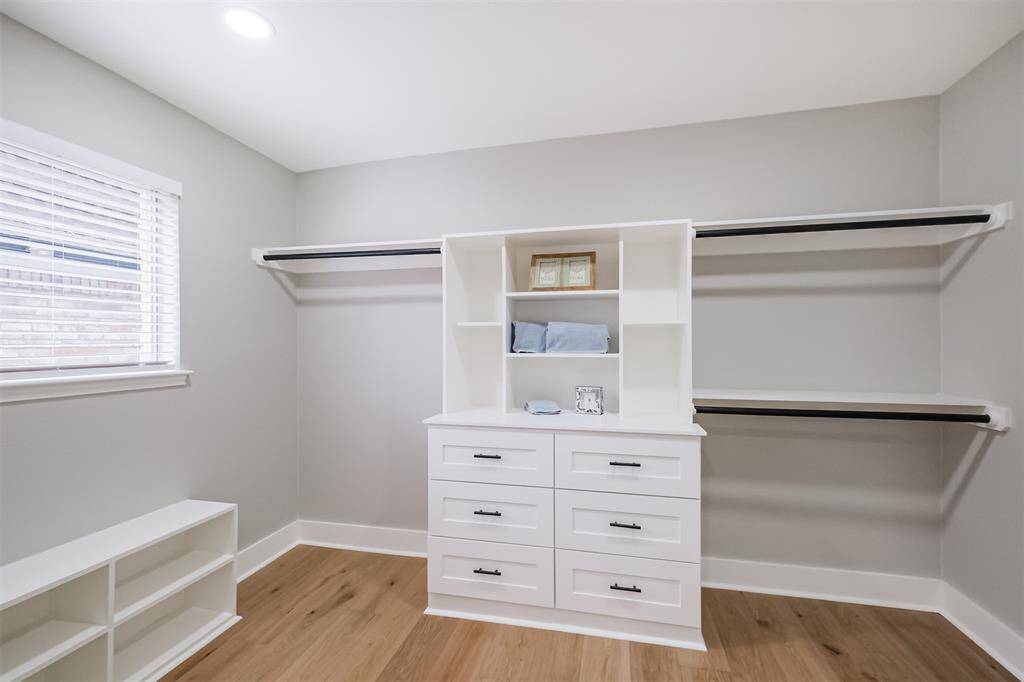 These wood built-ins are classic and functional. Drawers, shelves and multiple hanging rods make space for all your attire.