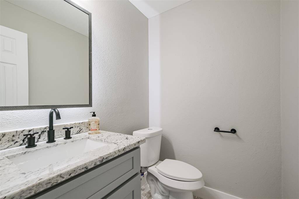 The conveniently located powder room provides a space for all your guests to use while entertaining.