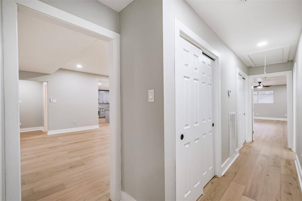 The hallway leading to the Owner's Suite boasts abundant storage, two secondary bedrooms and a large secondary bathroom.