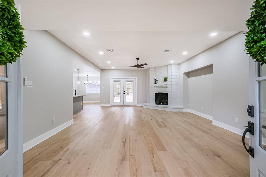 Cross the front porch and enter through the elegant double doors. You will be enchanted by this open concept, one-story home with views straight to the back garden.