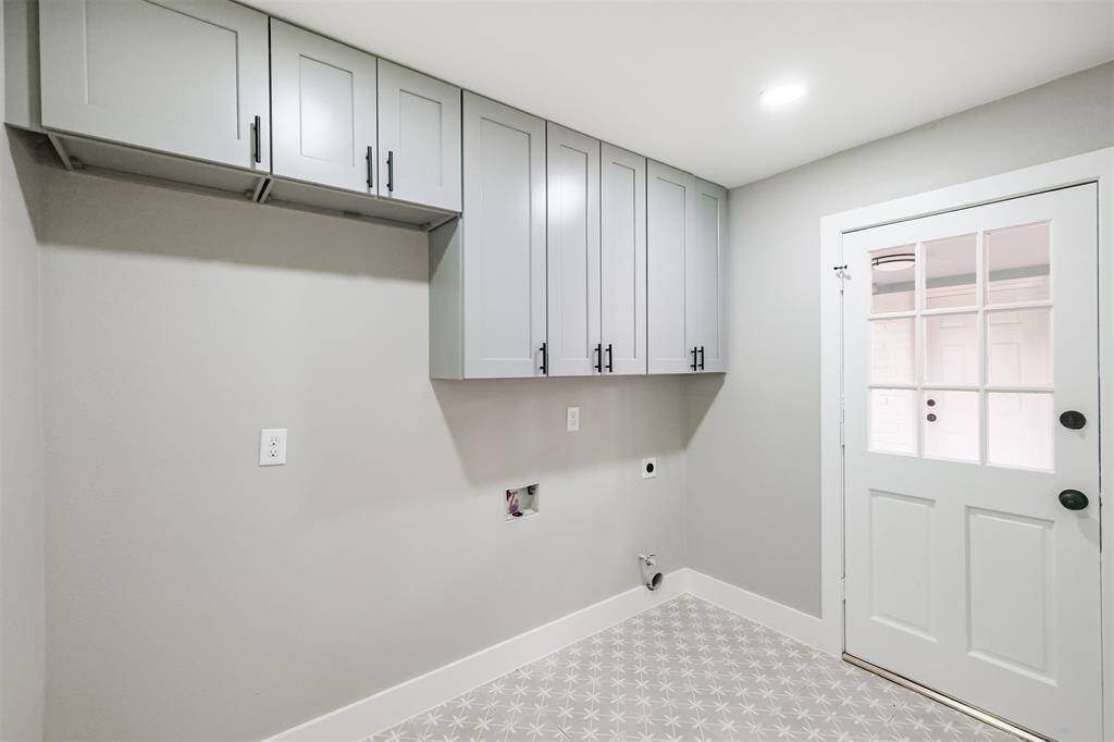 Built-in storage and whimsical tile greet you when you enter this room. Notice the extra room for a second refrigerator and convenient back door entrance to the breezeway.