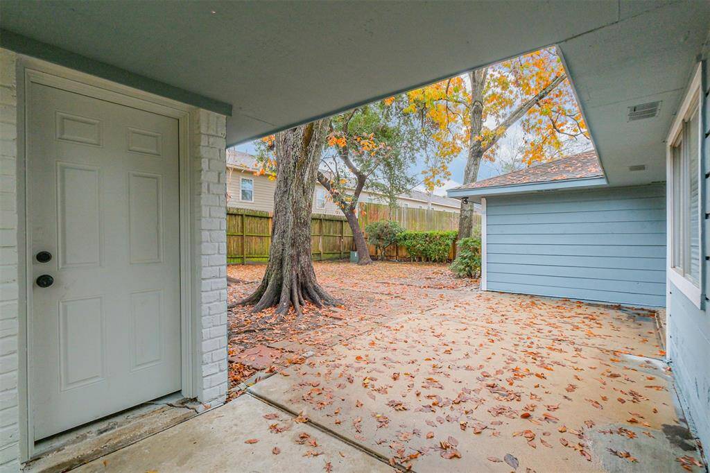 Step out onto the covered walkway and entrance to the garage. Just think how convenient carrying in your shopping will be.