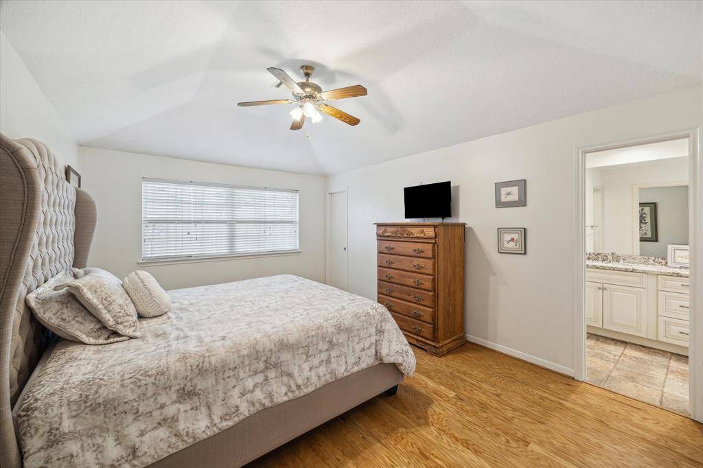 The primary bedroom features a space for a king-sized bed and full-sized complimentary furniture.