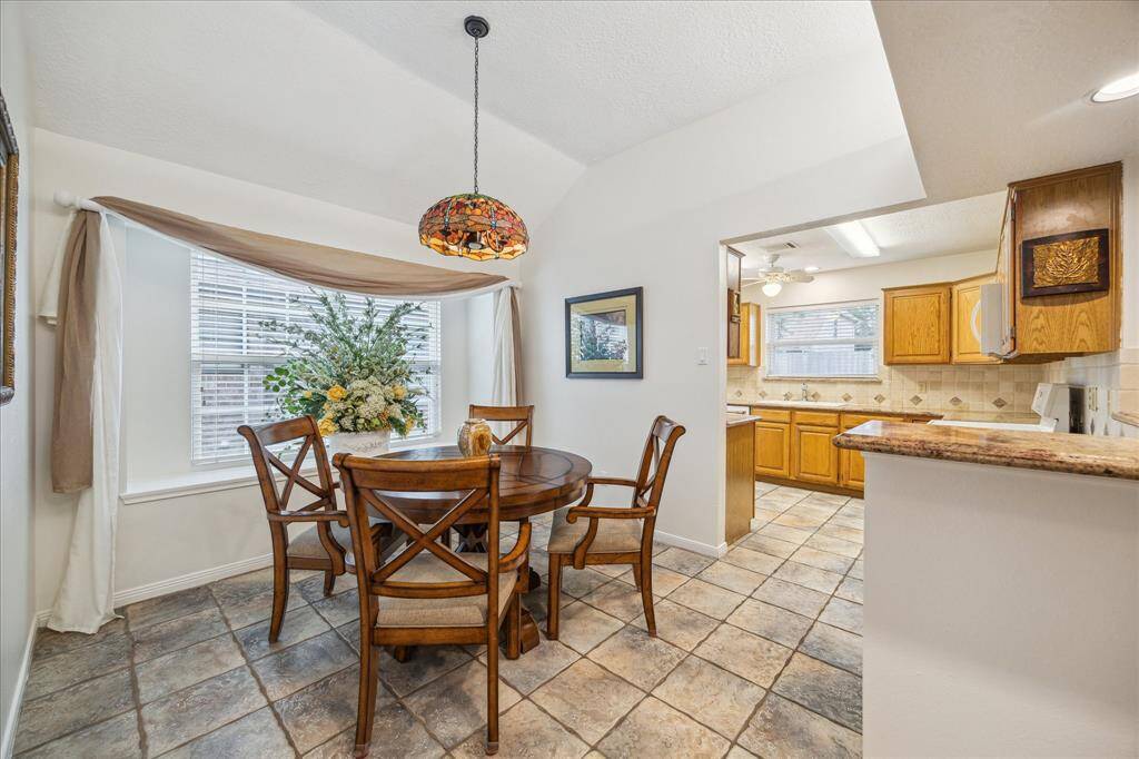 The dining area features a bay window and opens into the kitchen.