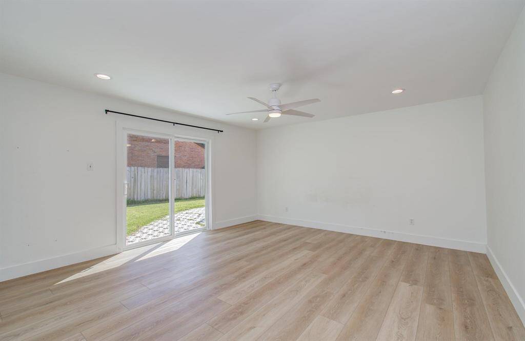 A large laundry room is off the kitchen with built in cabinets for storage.