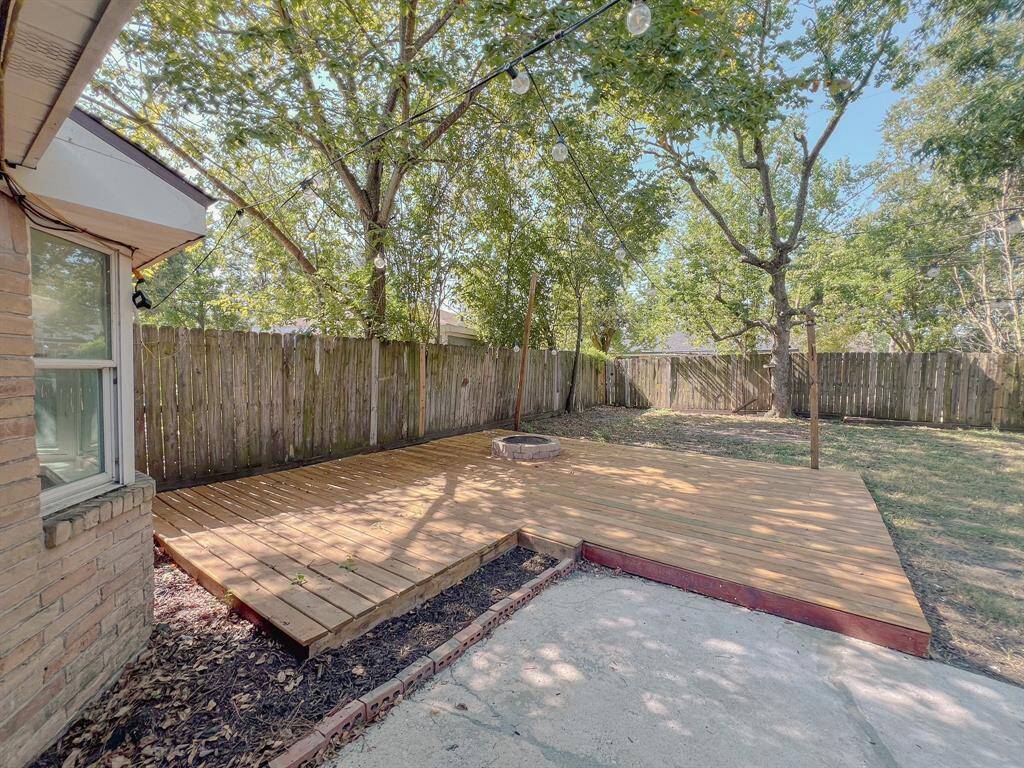 Outside patio with fireplace and lights