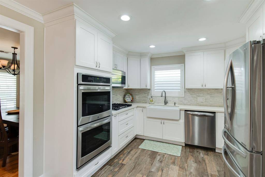 The bright and cheerful kitchen is inviting and allows for a lot of people and room for food preparation.