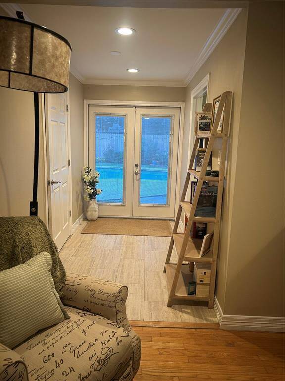 French doors lead from the bonus space in the primary bedroom to the outdoor living space, which includes a walk-in closet and bathroom.