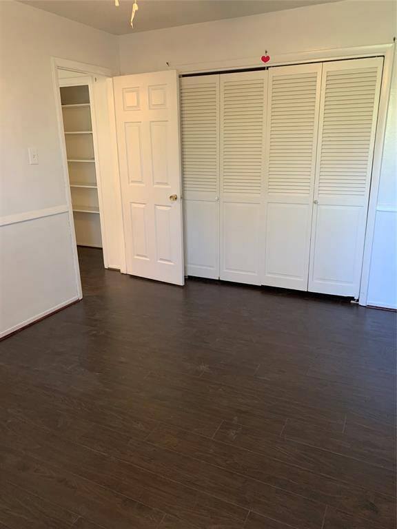 Secondary bedroom #2 additional view upstairs. Wood flooring throughout home!