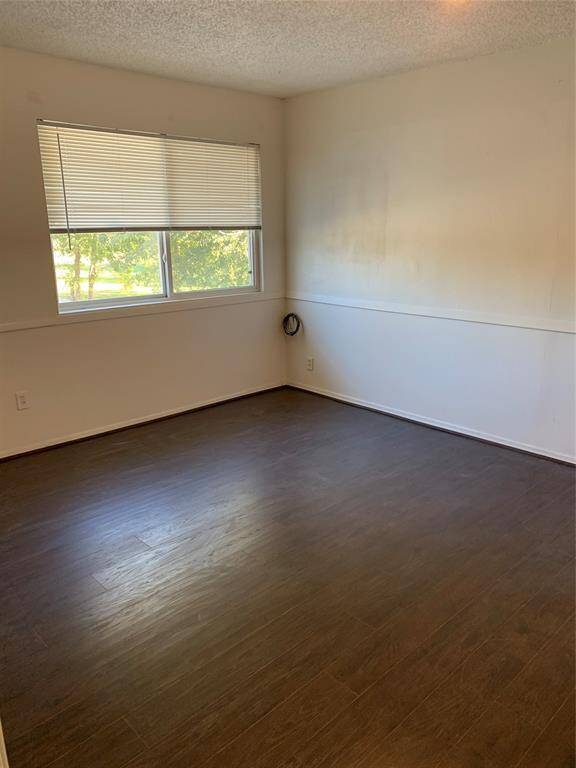 Secondary bedroom #3 upstairs. Wood flooring throughout home!