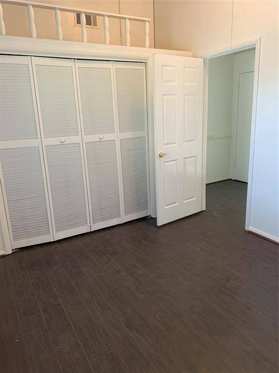 Secondary bedroom 1 alternate view. Wood flooring throughout home!