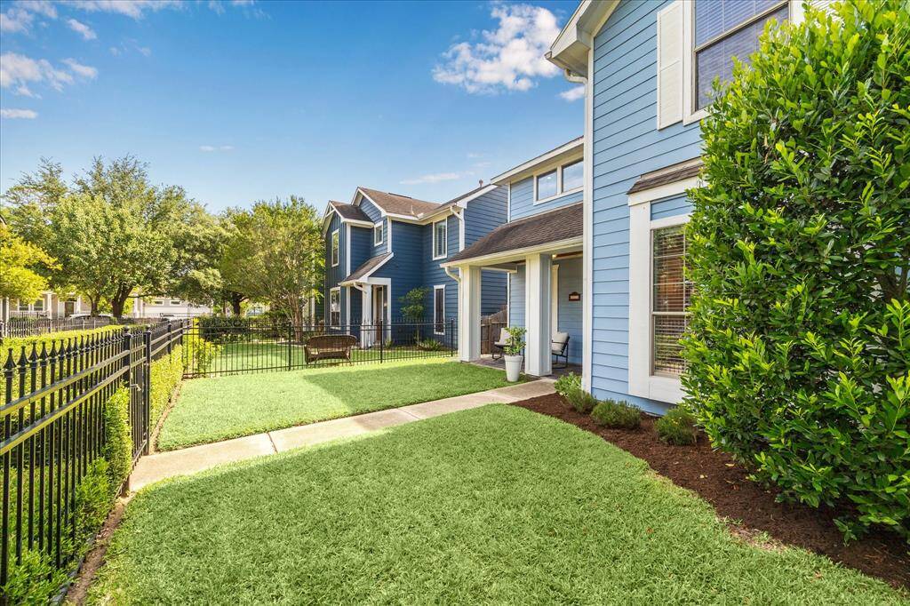 All properties in this quiet enclave have large front yards. Puppies can play while you enjoy your morning coffee on the porch or indoors. A garden gate at the top of the sidewalk welcomes your friends and neighbors.    The backyard has a wooden fence.
