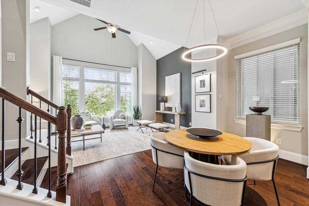 The stylish, open-concept dining area features a circular LED chandelier and seamlessly connects to the kitchen, enhancing flow and functionality for gatherings.