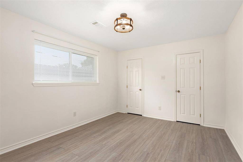 Secondary bedroom with two closet doors for easy-organizing.