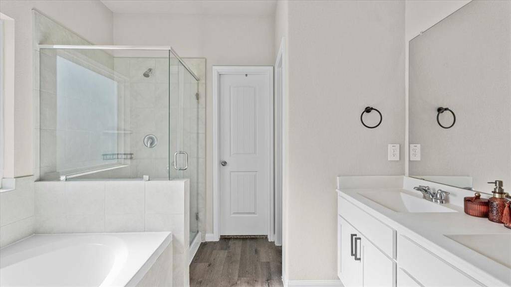 Spacious primary bathroom with garden tub, shower and large closet