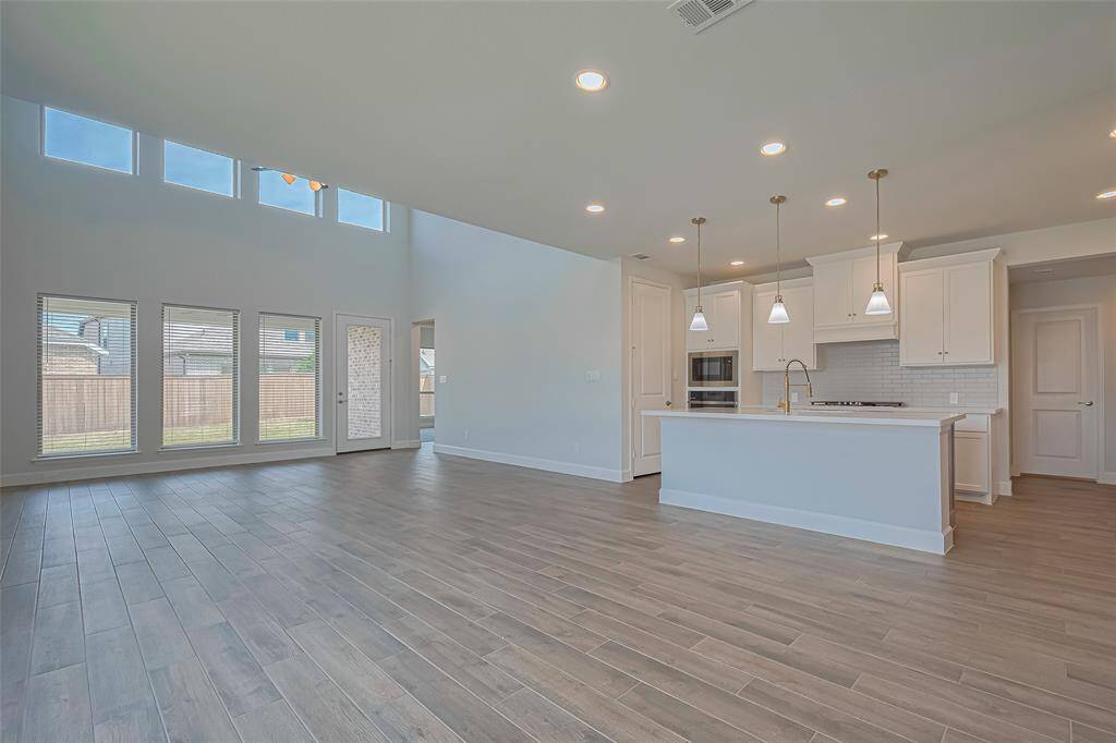 Two story soaring ceilings in the living room with wall of windows