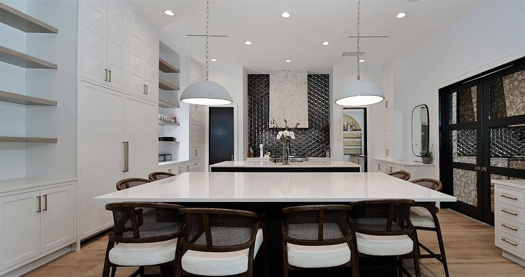 This dual island kitchen with SubZero and Wolf appliances, nugget ice maker, soft close cabinetry and drawers, and adjacent scullery will be the place to create incredible meals and memories for years to come!
