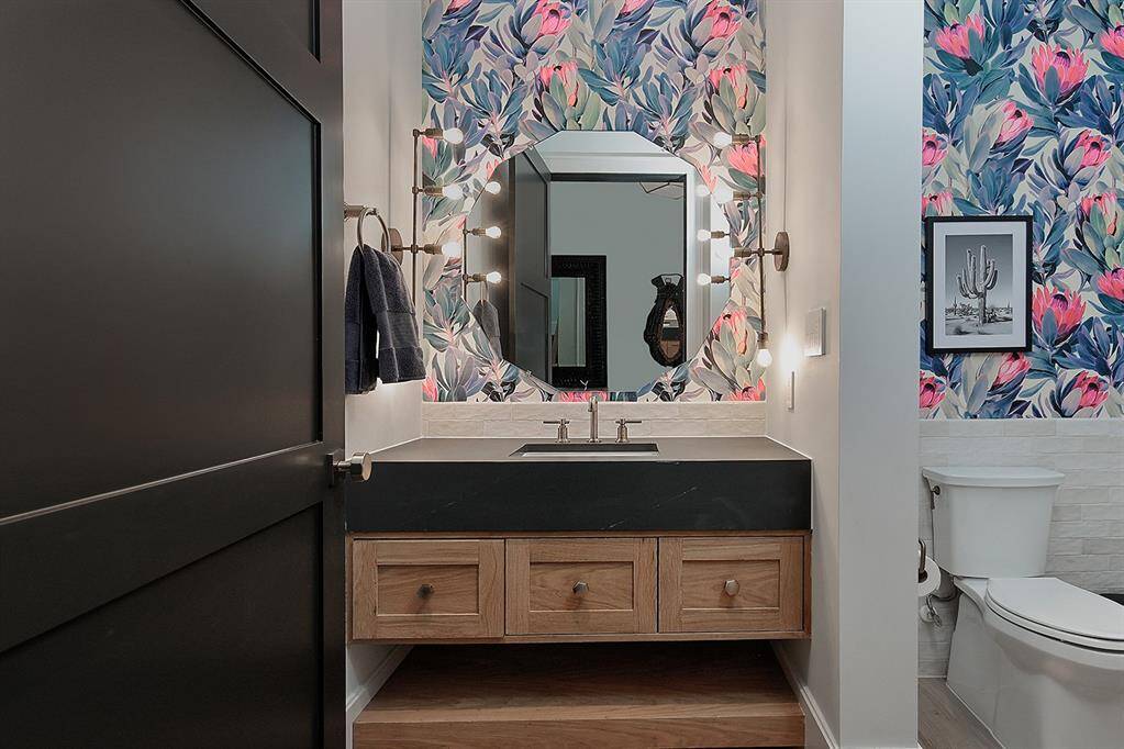 Here's the 1st of 3 guest baths, with beautiful lighting, counters, sink and wallpaper.