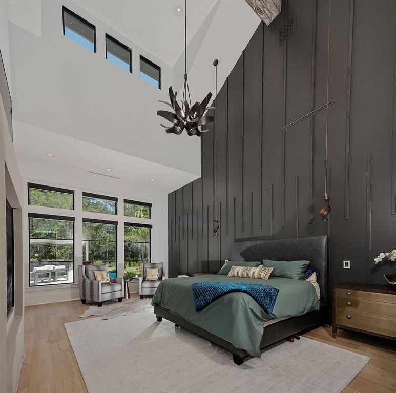 The primary suite downstairs has a vaulted wood beam ceiling, cozy fireplace and decorative wall.
