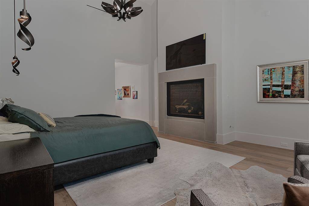 Here's a view of the fireplace in the primary suite, with some of the pendant lights for reading.
