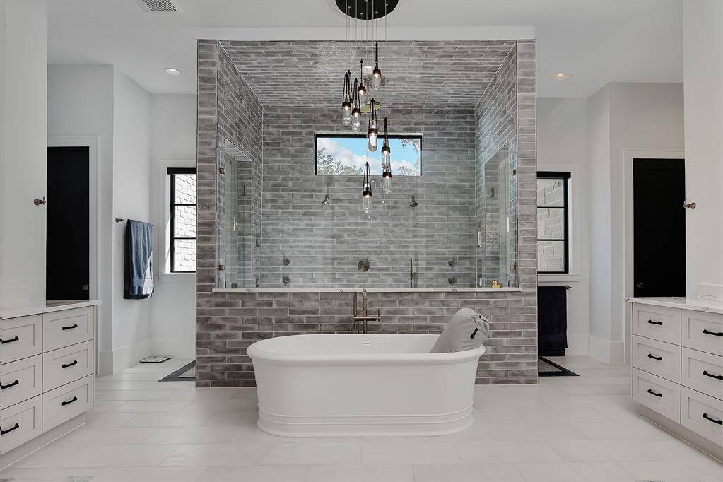 This primary bath is the epitome of luxury! With a free standing soaking tub, enormous shower and two walk-in closets that would rival any store showroom.