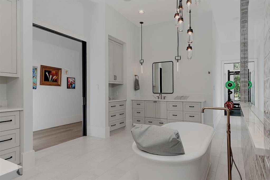 This primary bath has an adjacent fitness room!