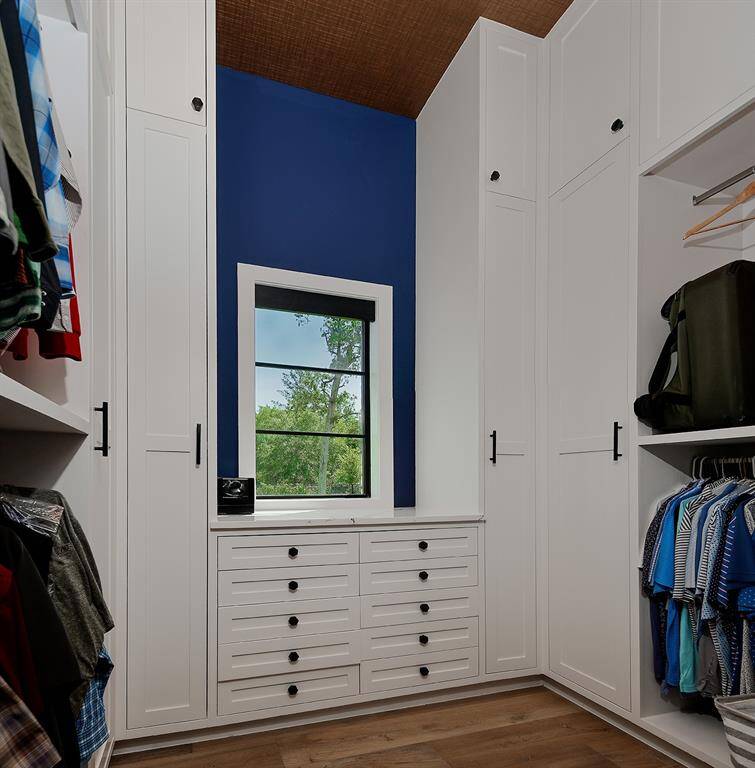 One of two closets in the primary bath, with custom built-ins.