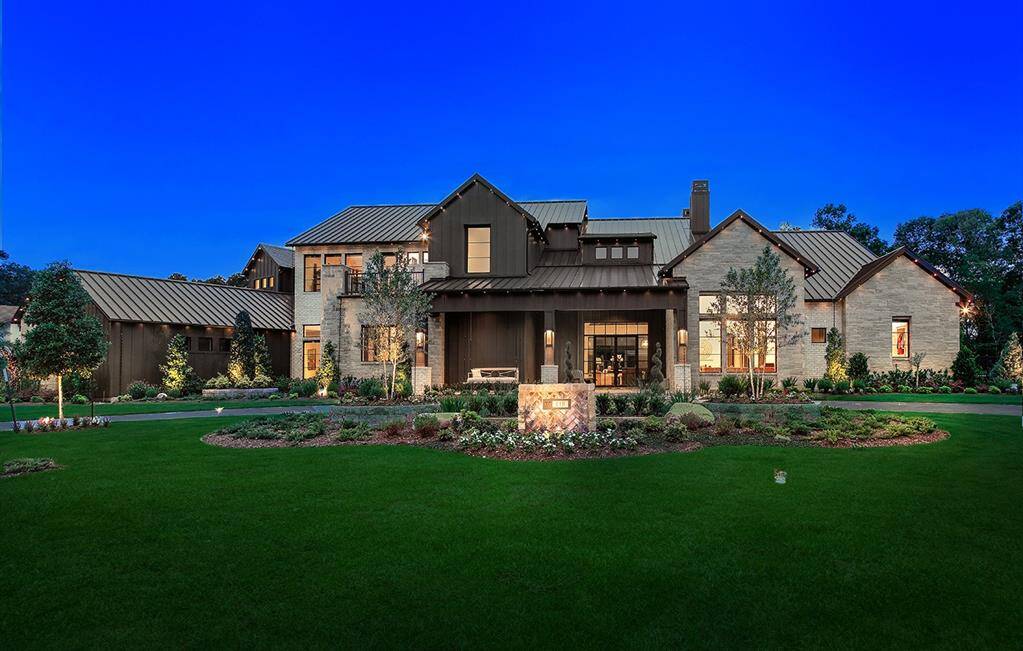 A four car garage, covered front porch, circular drive and meticulous landscaping add to the spectacular curb appeal of this home.