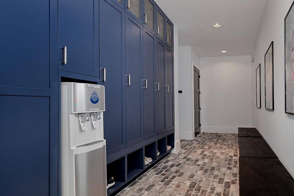 This mudroom with convenient filtered water bottle filling station is located by the garage.