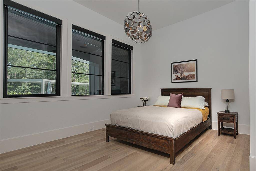 The secondary guest bedroom suite downstairs has a spacious closet and attached bath.