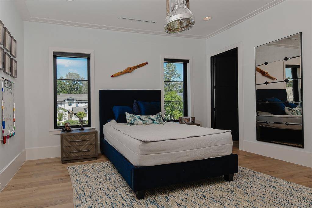 Each guest bedroom upstairs has an en-suite bath and walk-in closet.  The consistent white oak floors are a beautiful touch, and each room has motorized shades.